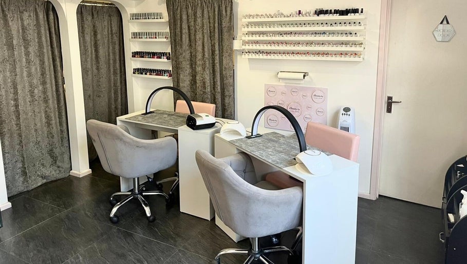 Chic nail stations at Beauty by Laura Jayne in Tutbury, England, GB. Modern decor with chairs and polish displays.