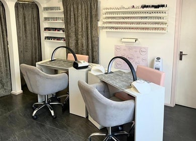 Chic nail stations at Beauty by Laura Jayne in Tutbury, England, GB. Modern decor with chairs and polish displays.