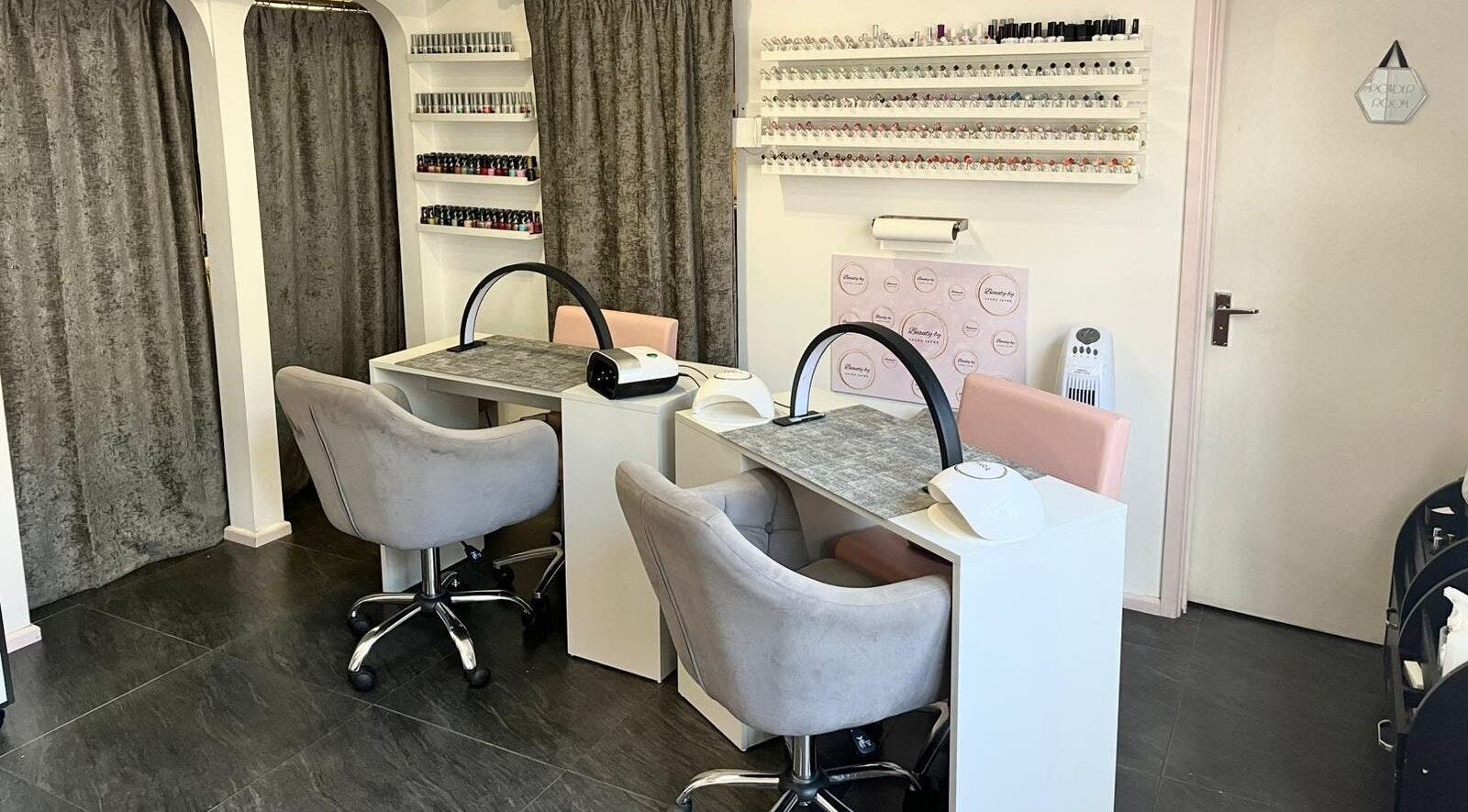 Chic nail stations at Beauty by Laura Jayne in Tutbury, England, GB. Modern decor with chairs and polish displays.
