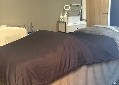 Relaxing treatment room setup at Natalies Beauty Room, Blandford Forum, England, GB with a cozy massage table.