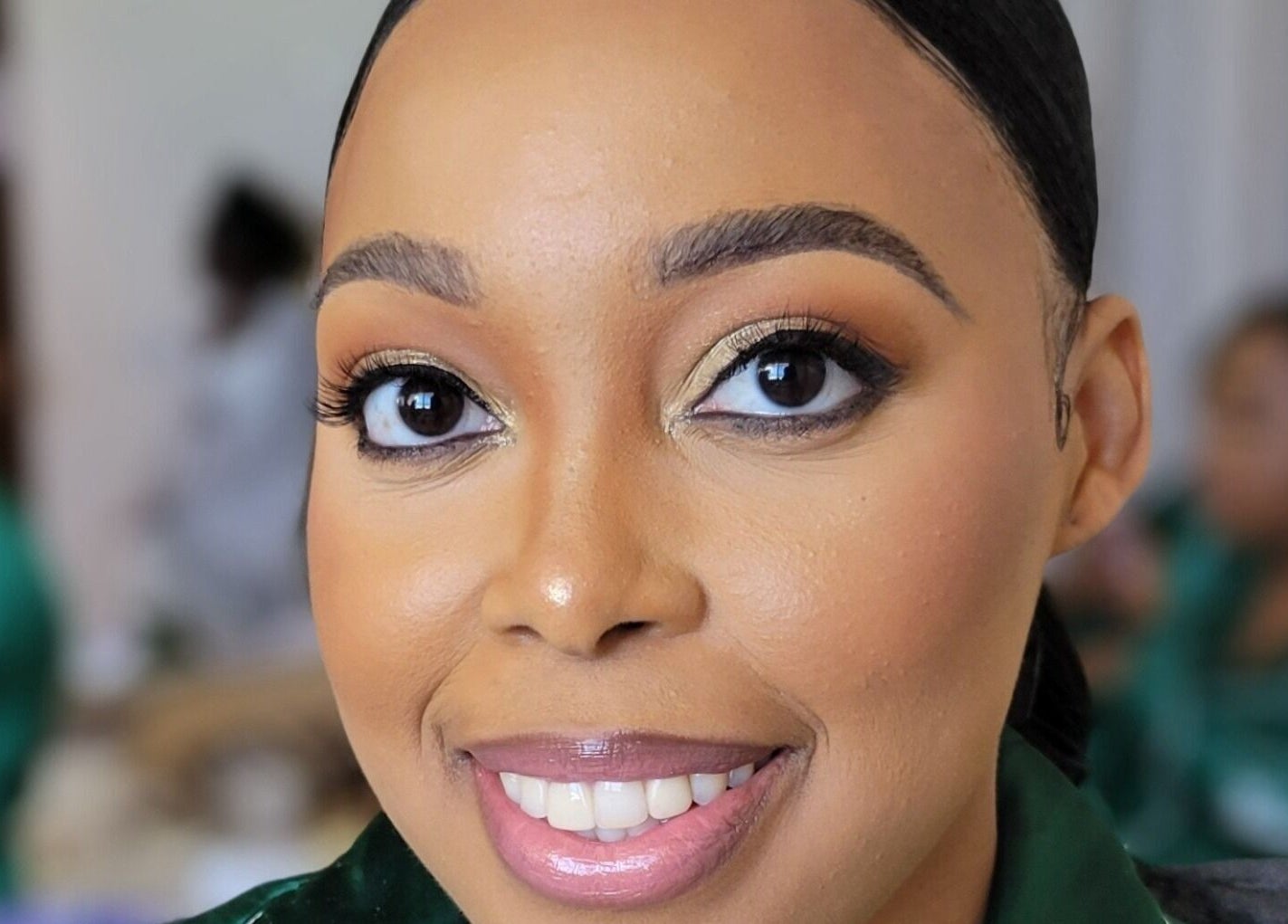 Close-up of a smiling woman's face after a makeover at Infinite Beauty Pro, Kingston, St. Andrew Parish, JM.