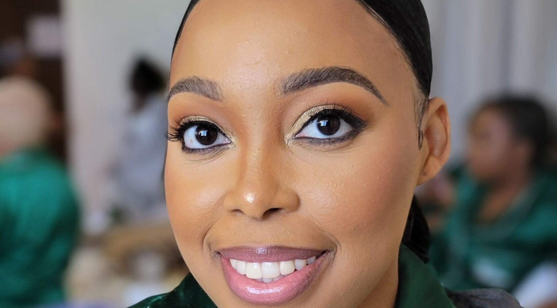 Close-up of a smiling woman's face after a makeover at Infinite Beauty Pro, Kingston, St. Andrew Parish, JM.