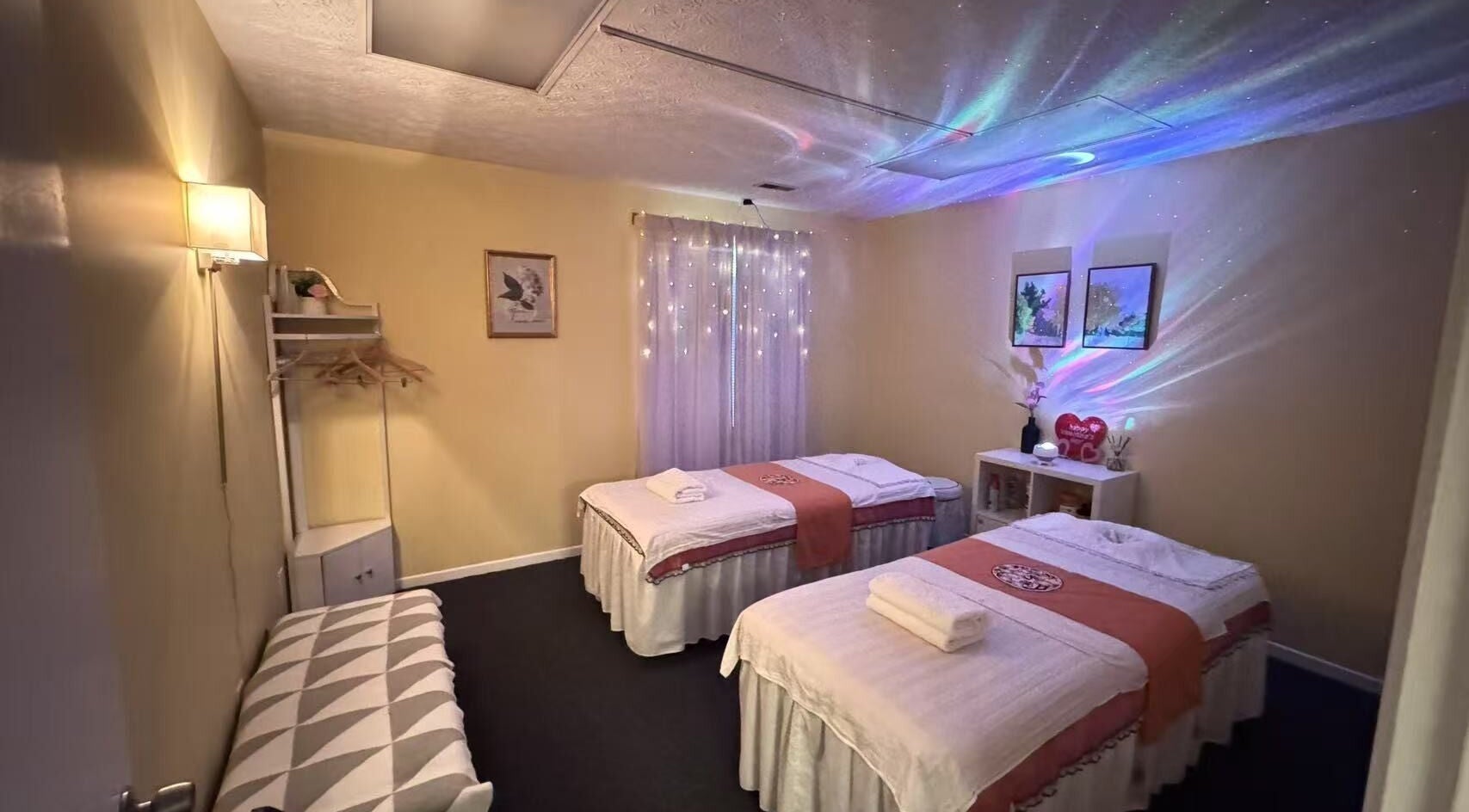 Relaxing massage room at Perfect Massage, Columbus, Ohio, US. Featuring soft lighting and double massage tables.
