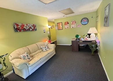 Inviting lounge at Perfect Massage in Columbus, Ohio, US, featuring a cozy sofa and a welcoming ambiance.
