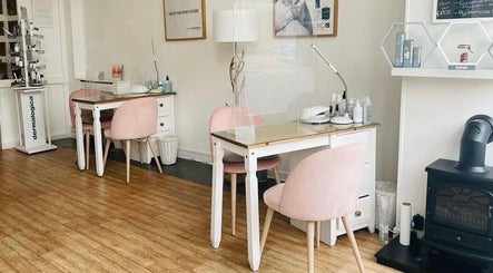 Chic nail service area at Nails By Sarah in Edinburgh, Scotland, GB, featuring pink chairs and modern decor.