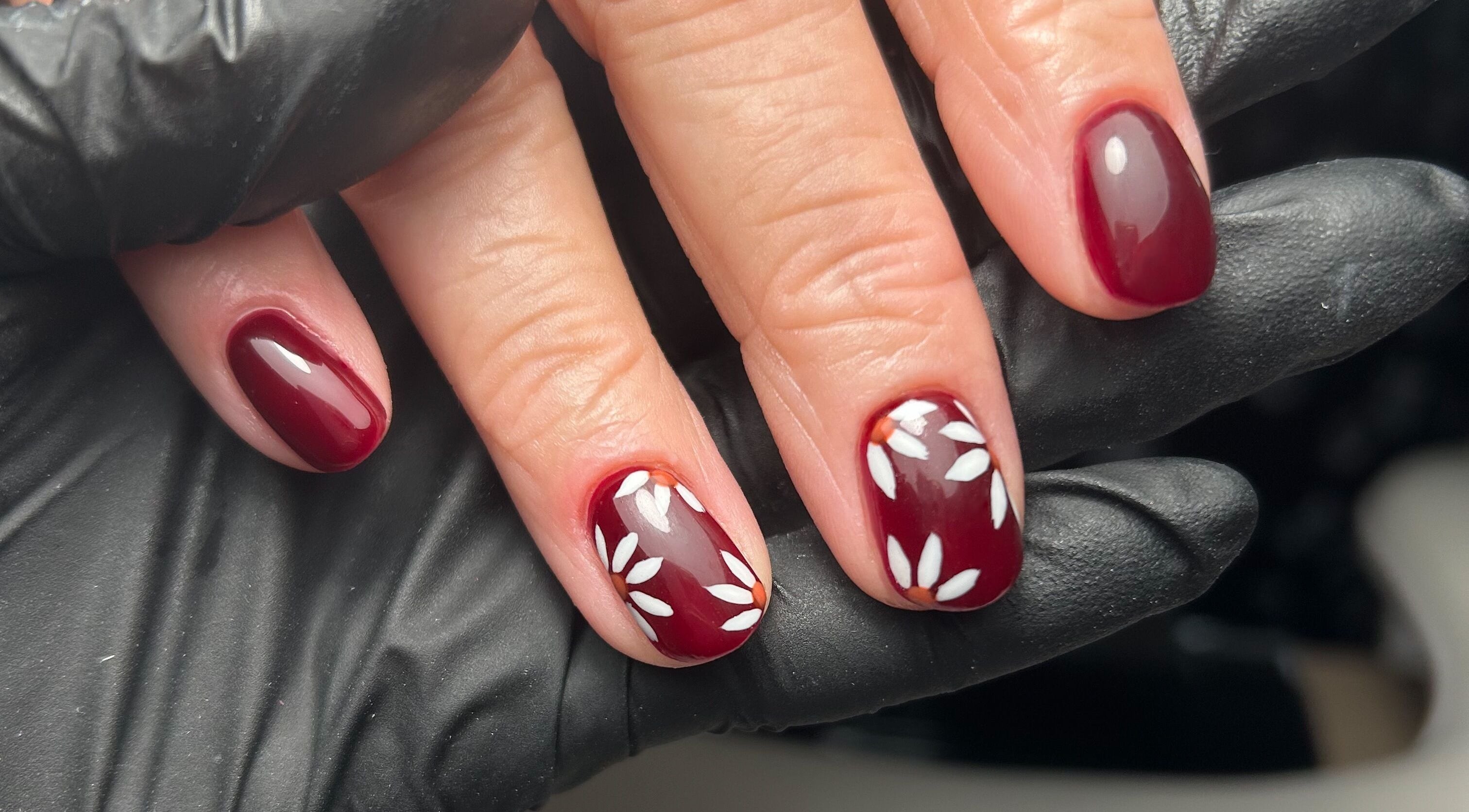 Elegant maroon nails with floral design at Nails By Sarah, Edinburgh, Scotland, GB.