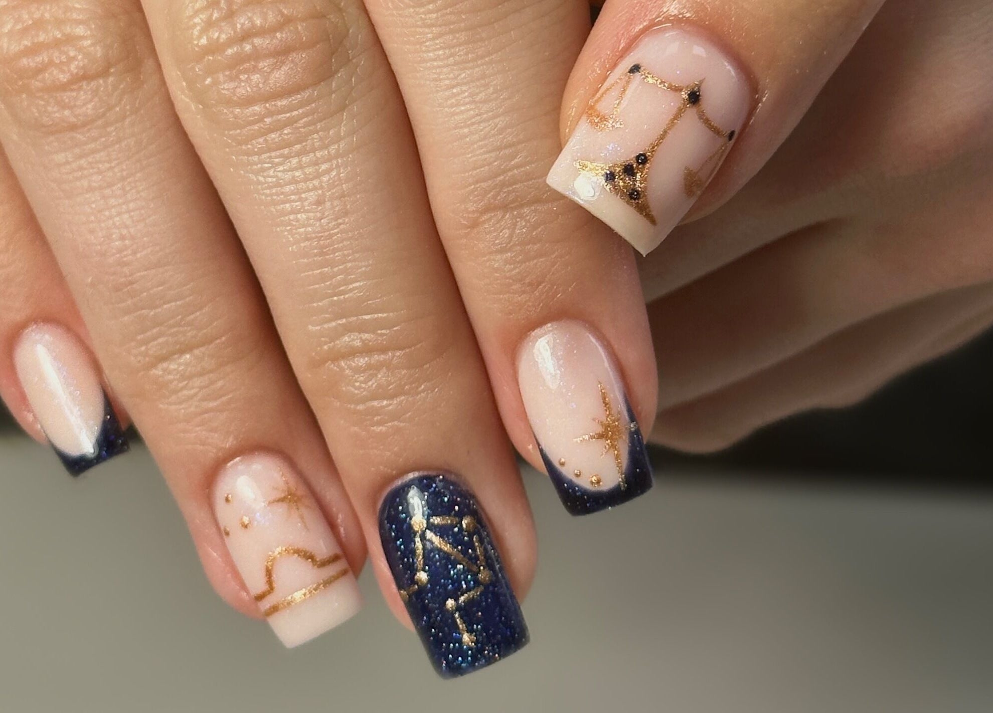 Astrological nail art design at Shape Studios, Cardiff, Wales, GB featuring starry blue and golden accents.