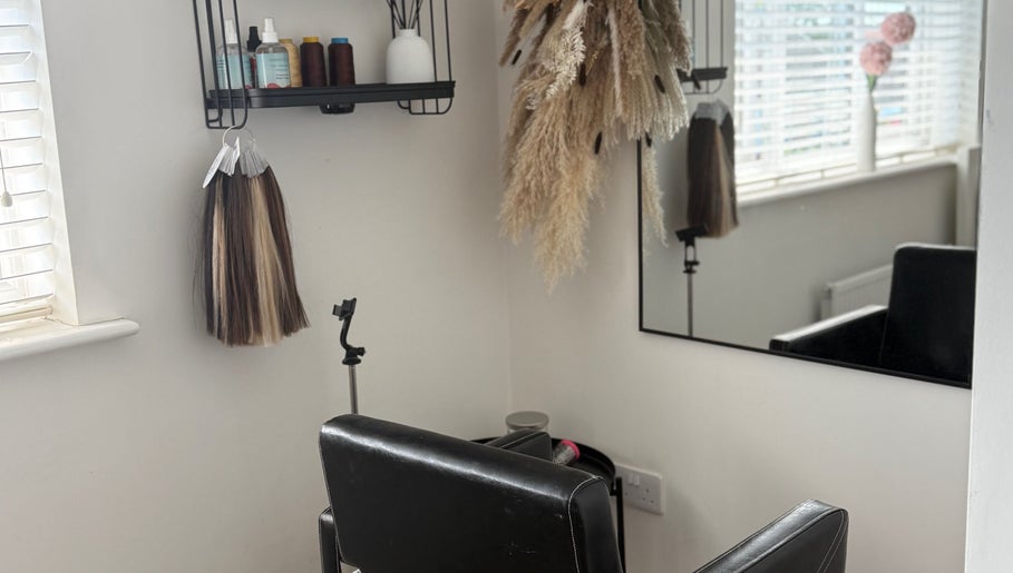 Cozy styling chair at No Audrey’Nary Locks, Tyldesley, England with elegant decor and hair products.