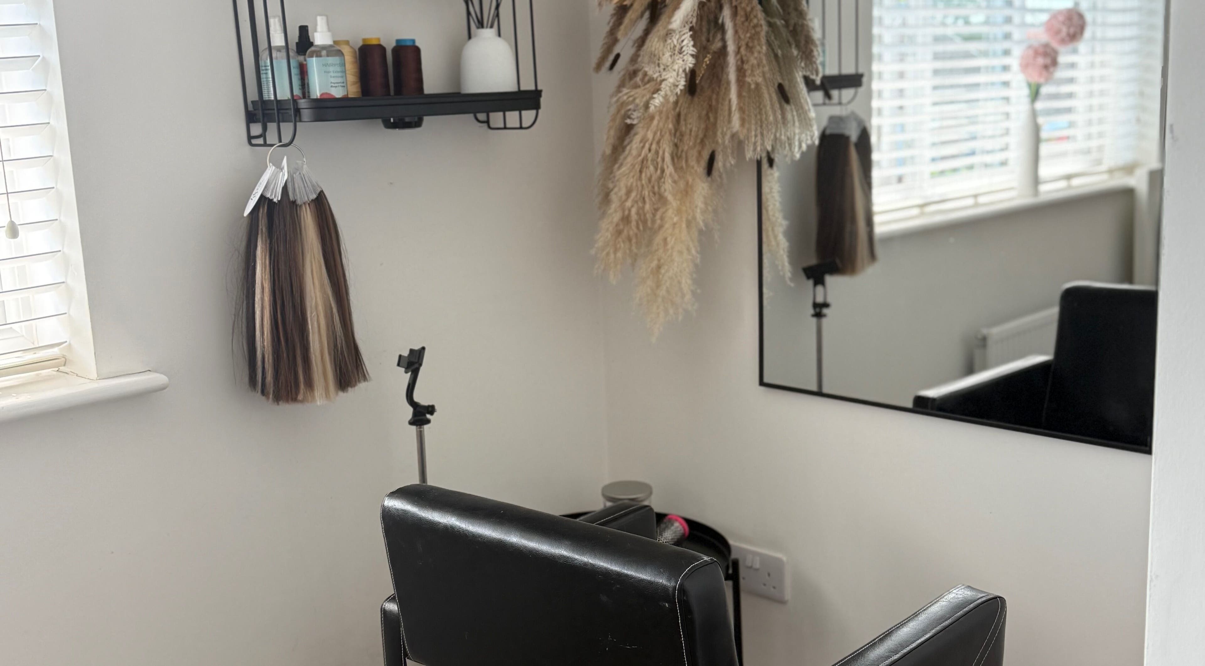 Cozy styling chair at No Audrey’Nary Locks, Tyldesley, England with elegant decor and hair products.