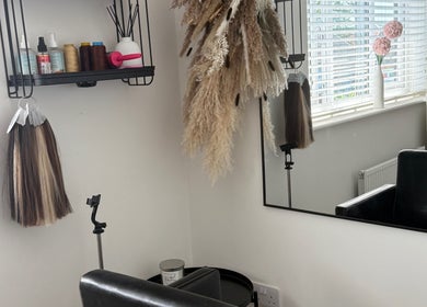 Elegant styling station at No Audrey’Nary Locks, Tyldesley, England, GB featuring a mirror and beauty products.