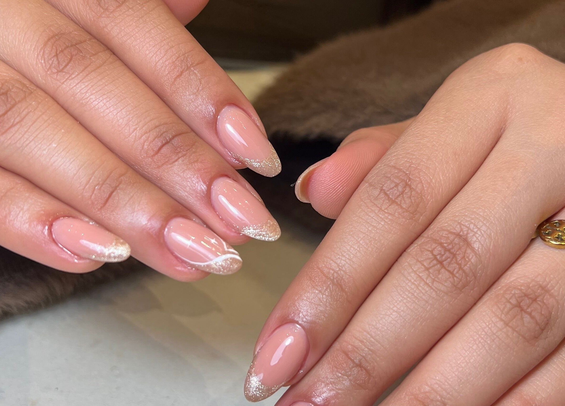 Elegant nails with pink polish and glitter tips at Aria Nail Bar and Spa, Al Khobar, Eastern Province, SA.