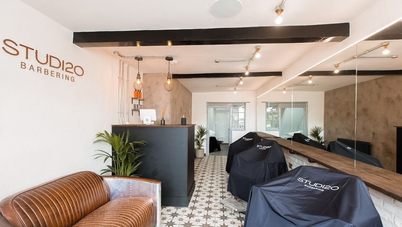 Interior of Studio120 in Bushey, England, showcasing modern decor and cutting stations.