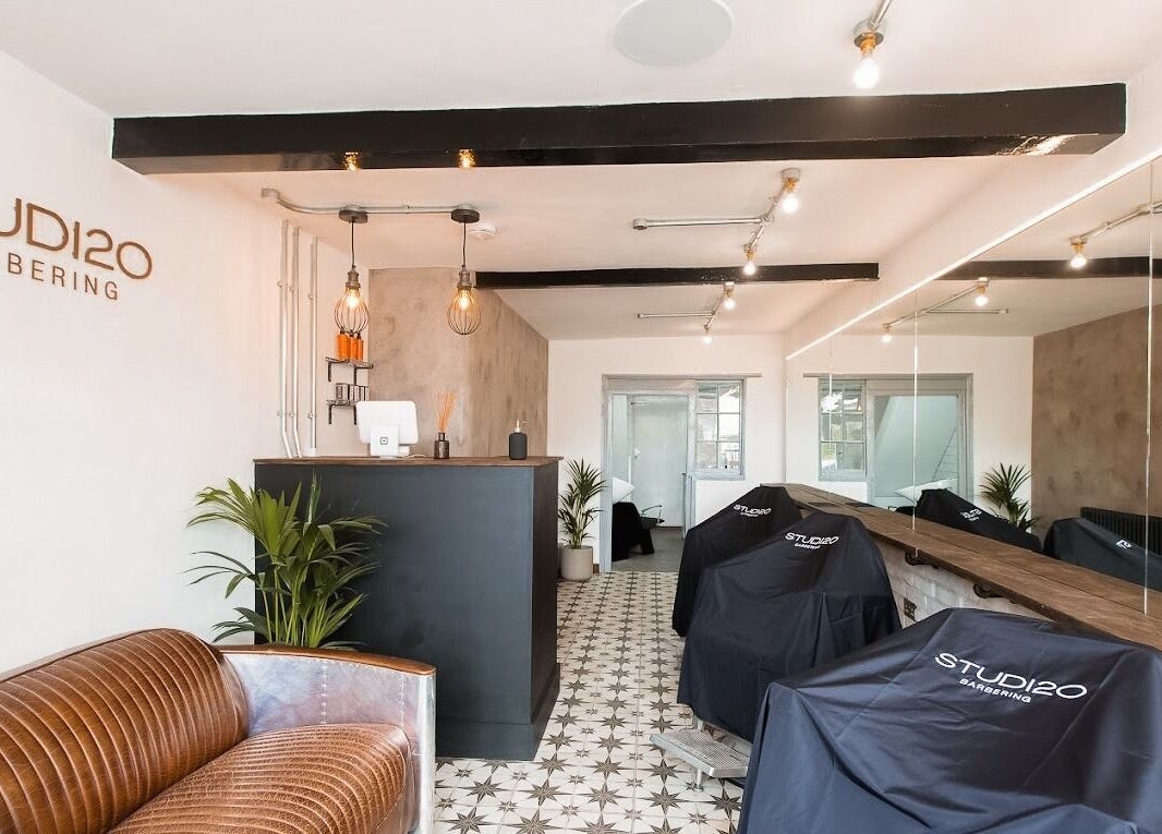 Interior of Studio120 in Bushey, England, showcasing modern decor and cutting stations.