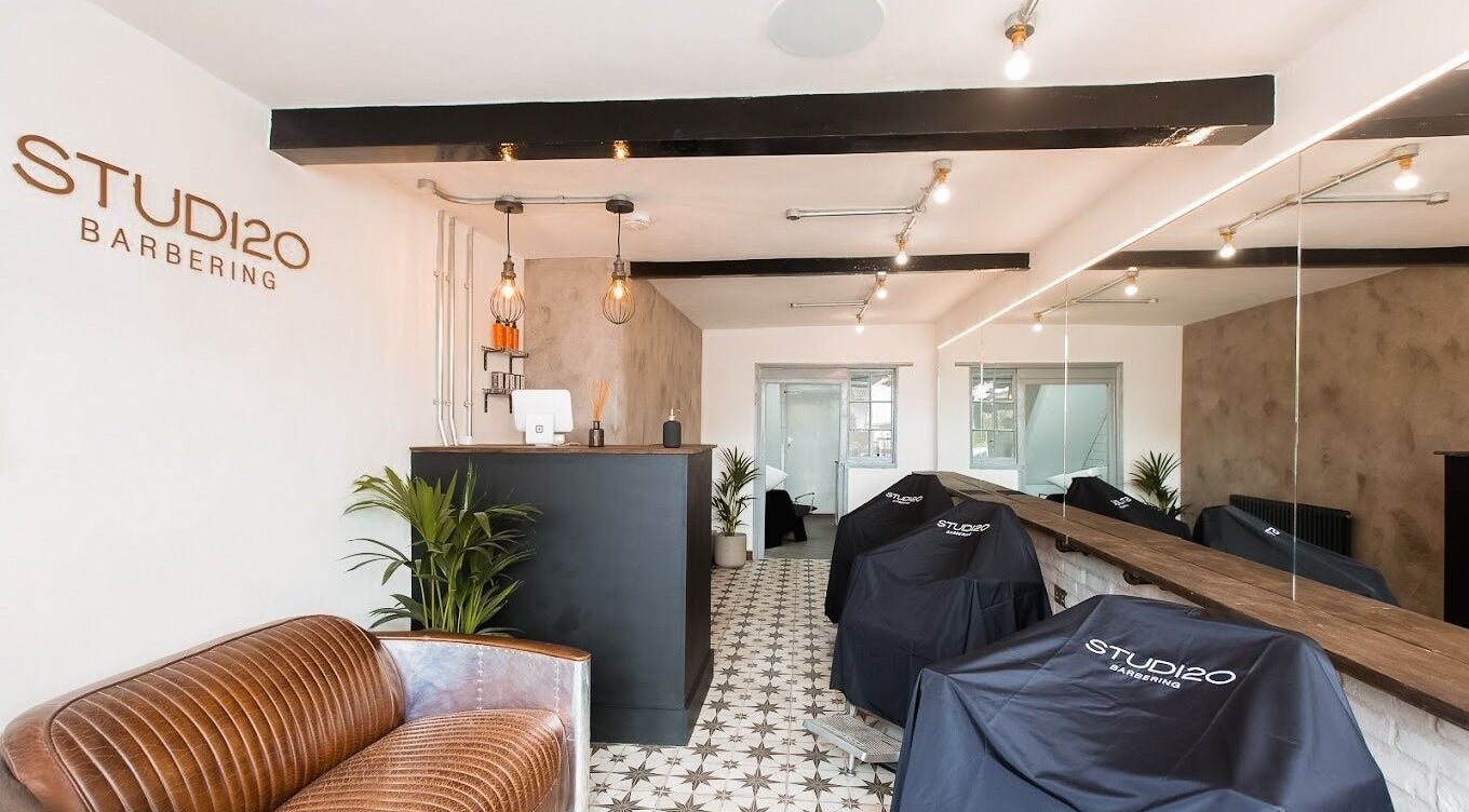 Interior of Studio120 in Bushey, England, showcasing modern decor and cutting stations.