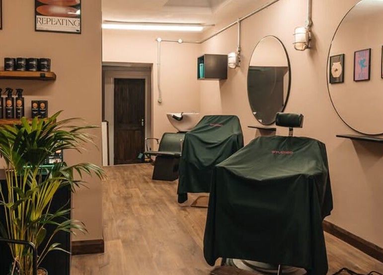 Cozy Studio120 interior showcasing modern salon setup in Bushey, England, GB with stylish mirrors and plant décor.