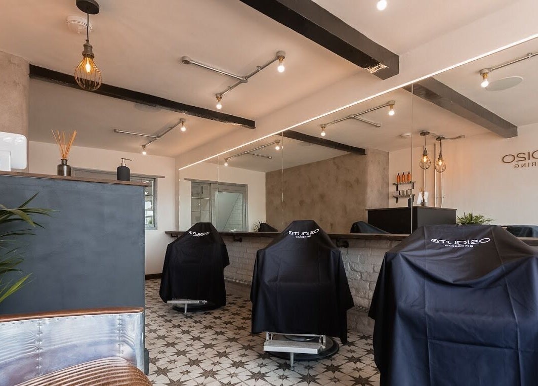 Modern barber chairs and stylish decor at Studio120 in Bushey, England, GB. Inviting and professional ambiance.