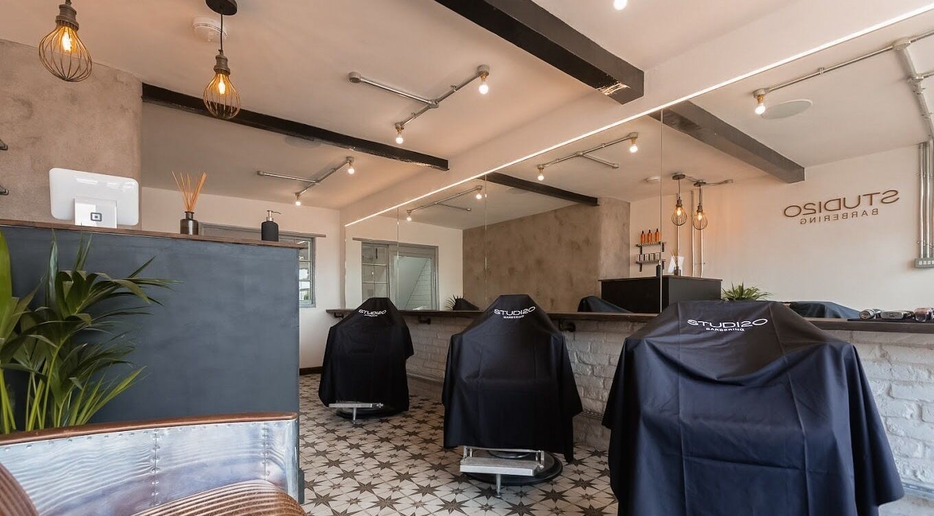 Modern barber chairs and stylish decor at Studio120 in Bushey, England, GB. Inviting and professional ambiance.