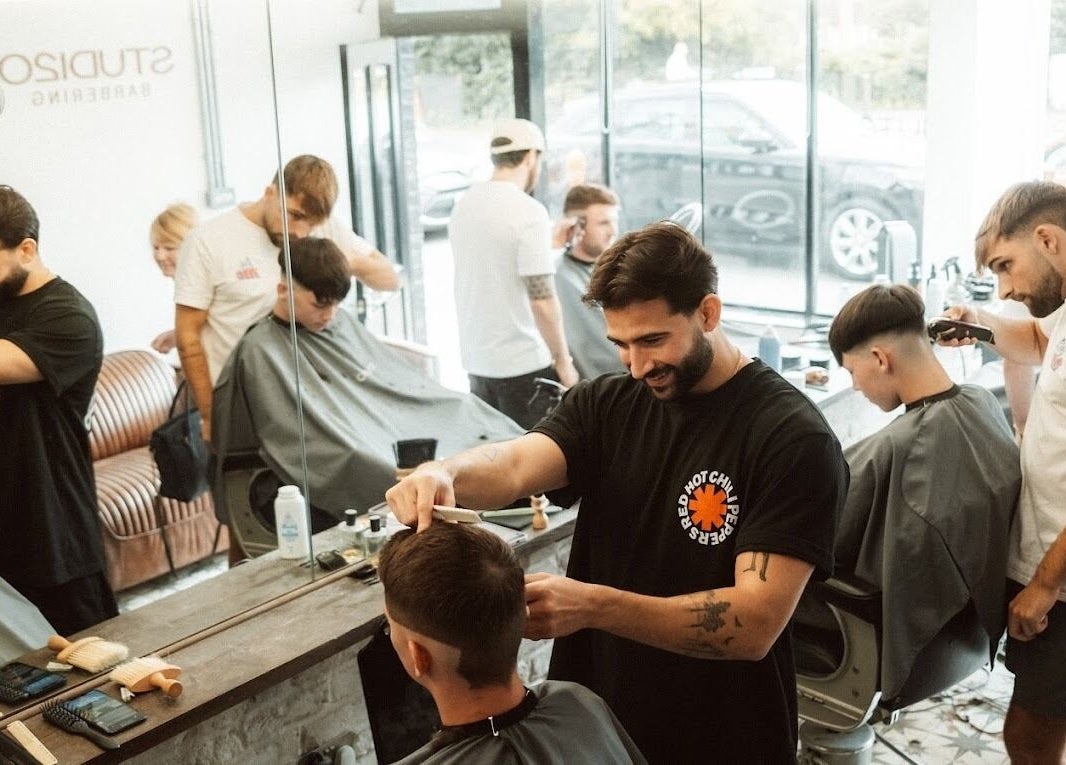 Professional barbers at Studio120 in Bushey, England, GB, crafting trendy hairstyles for clients.