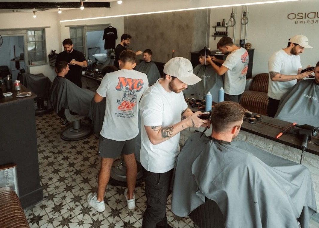 Guests receiving haircuts at Studio120, a vibrant salon in Bushey, England, GB.