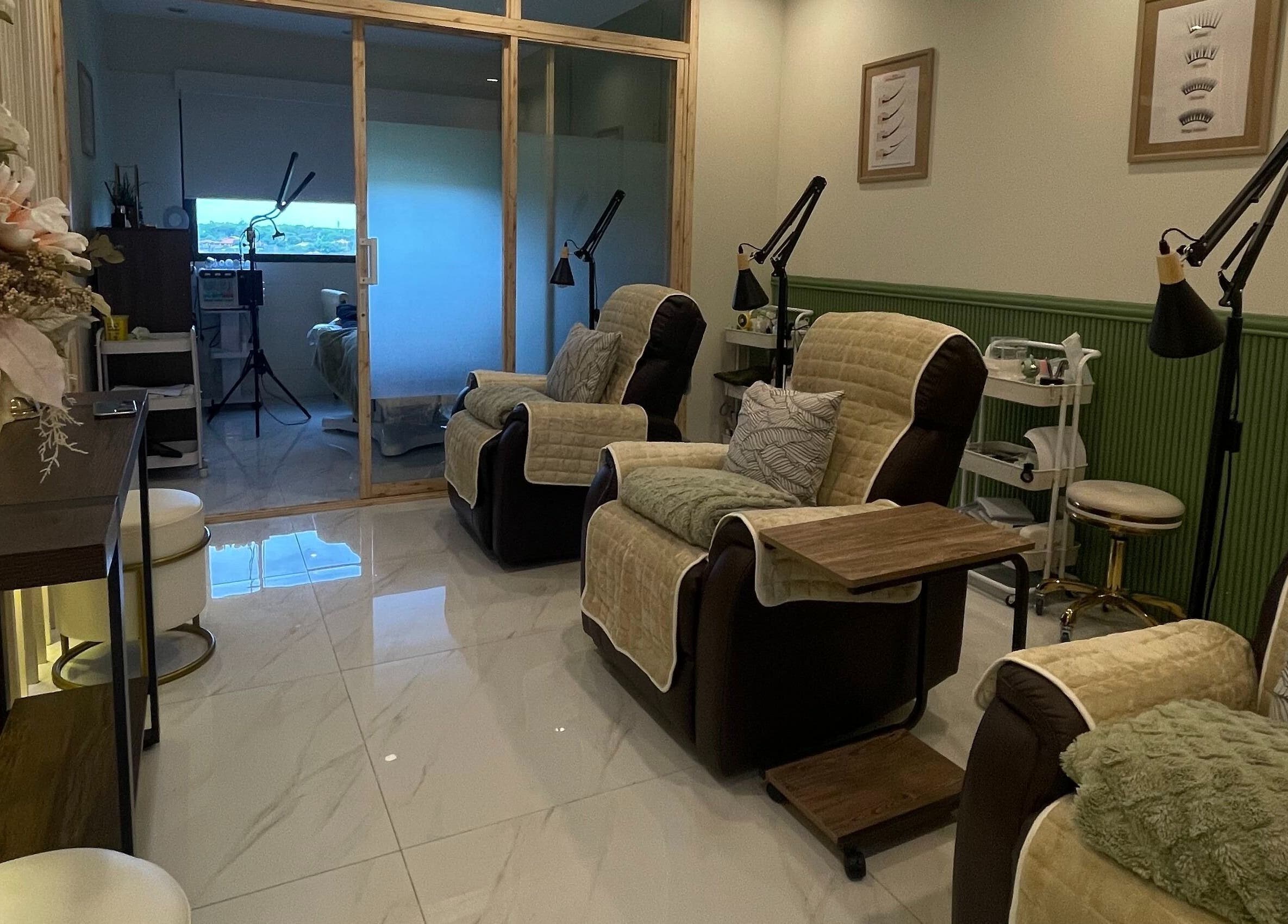 Elegant spa lounge at Le’ Brows Premieré, Muntinlupa, Metro Manila, PH, with cozy seating and floral decor.