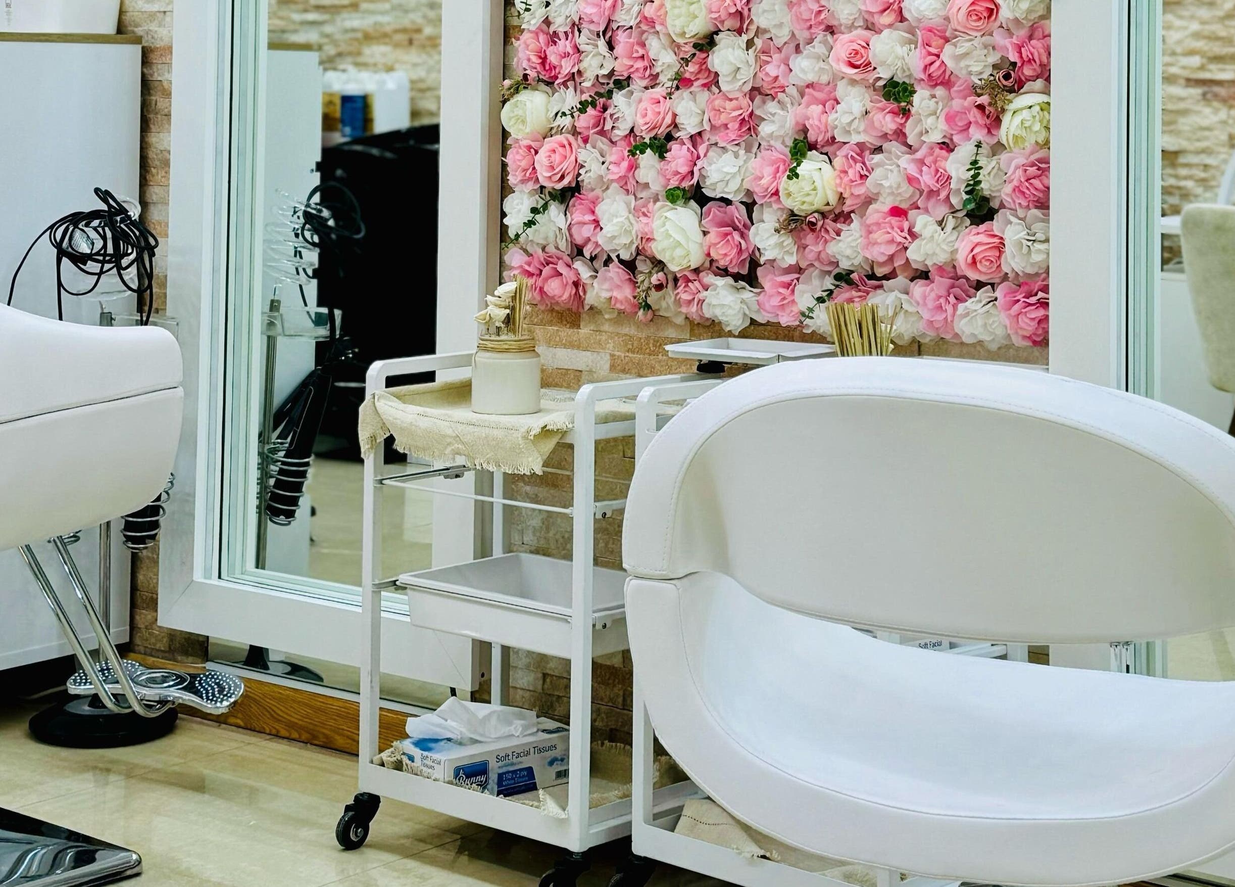 Elegant interior of Korean Digital Perm Salon in Dubai, Dubai, AE, featuring floral decor and modern chairs.