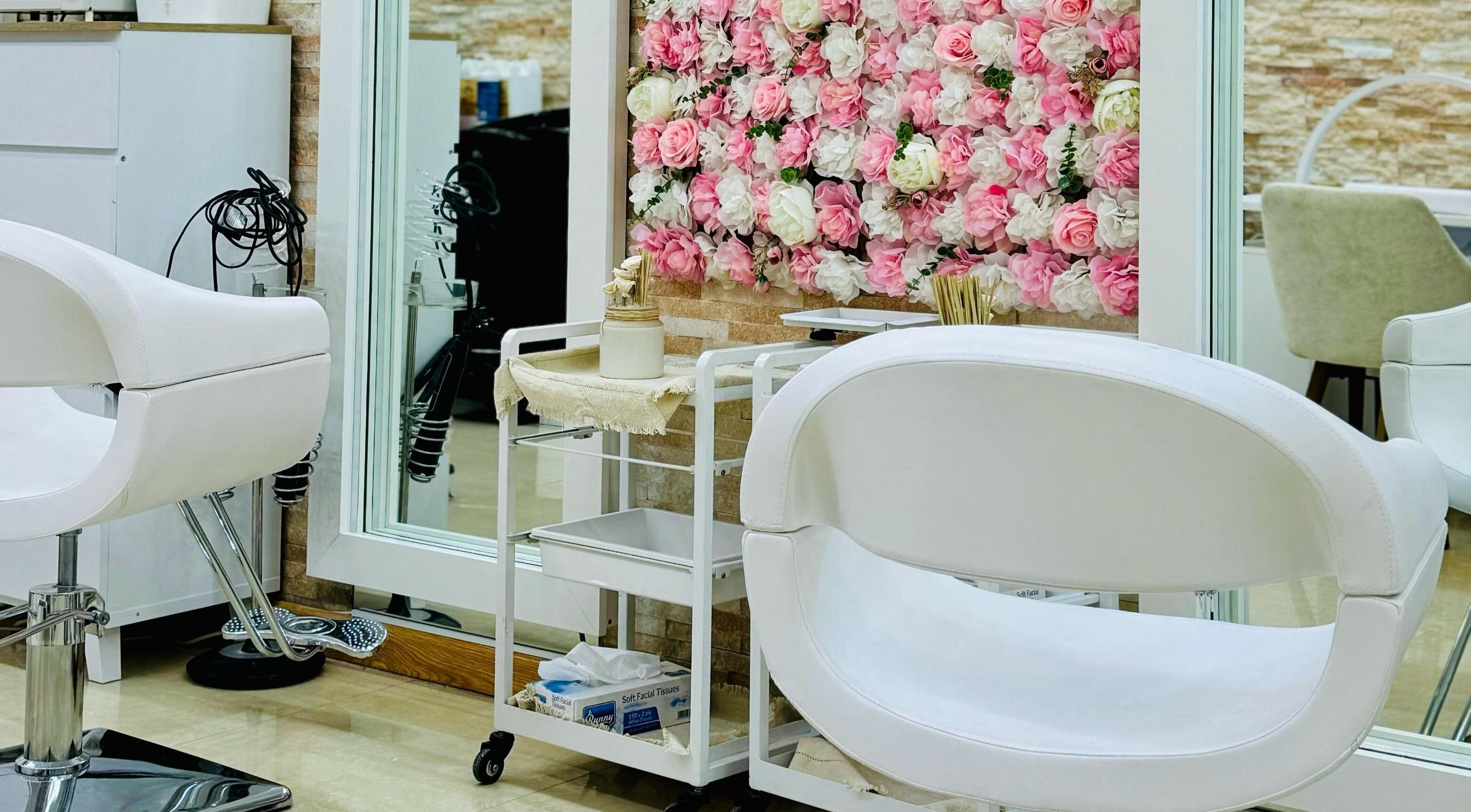 Elegant interior of Korean Digital Perm Salon in Dubai, Dubai, AE, featuring floral decor and modern chairs.