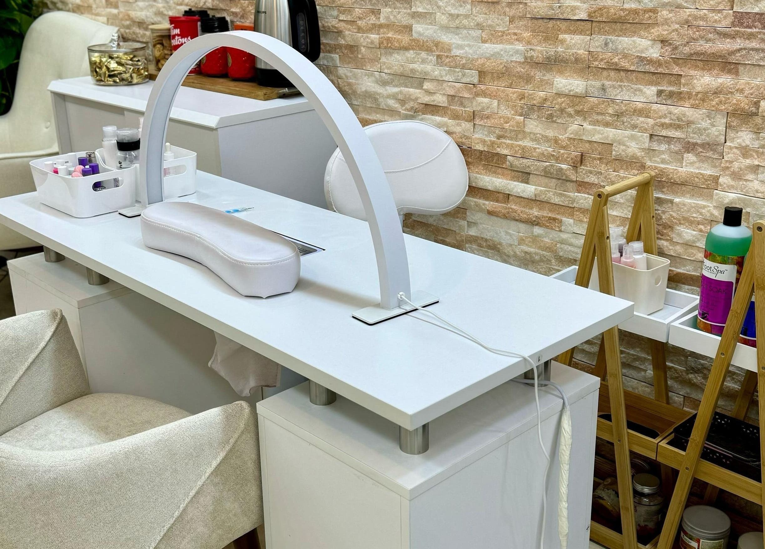 Chic nail station at Korean Digital Perm Salon, Dubai, Dubai, AE. Modern design with beauty products on display.