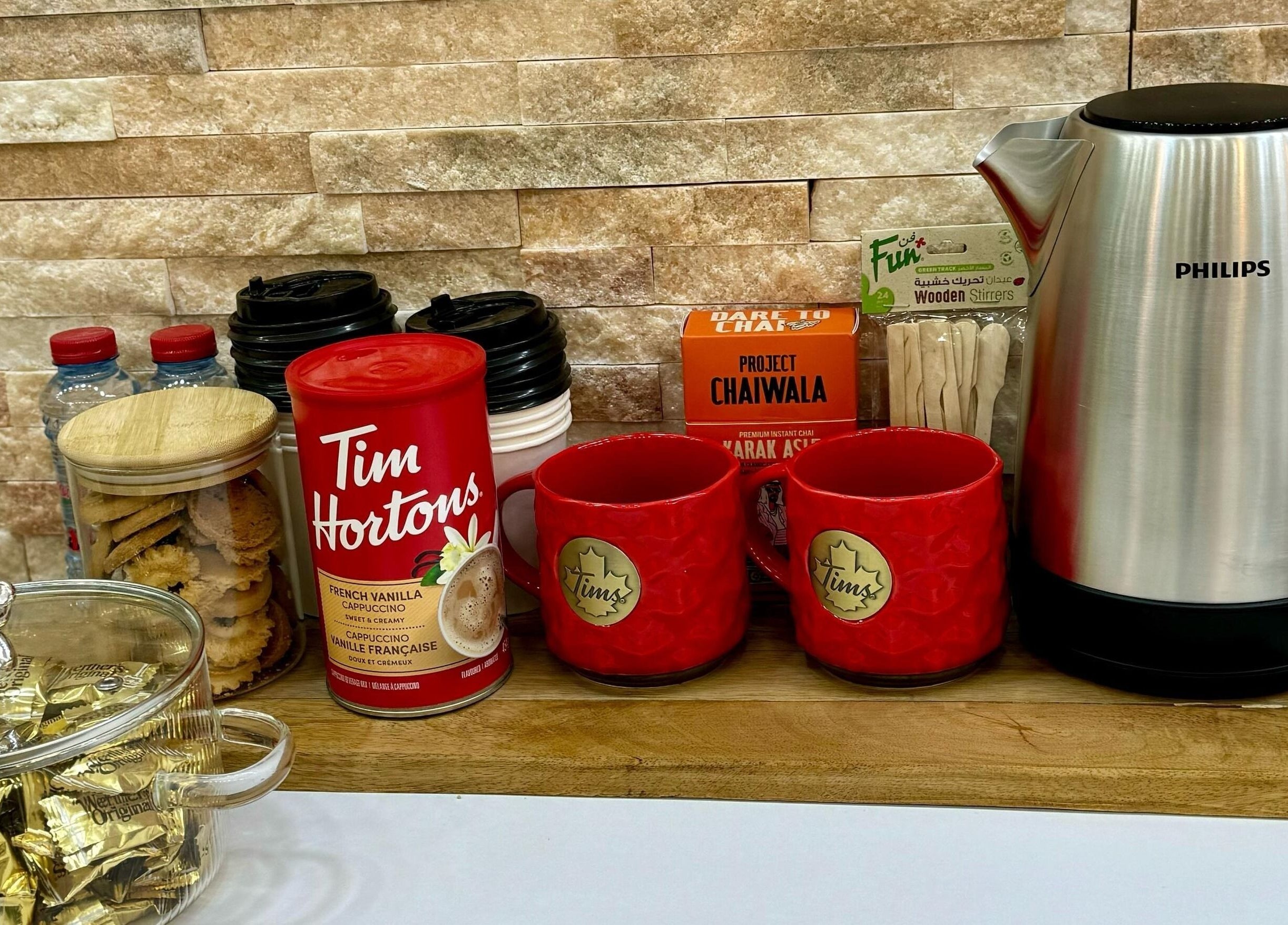 Beverage station at Korean Digital Perm Salon, Dubai, Dubai, AE featuring a variety of drinks and snacks.