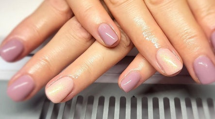 Manicured hands with glossy nails at Simply Nails and Wellbeing in Crawley, England, GB.