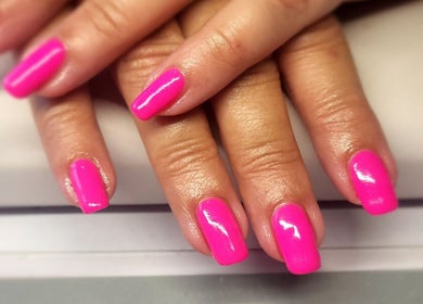 Bright pink manicured nails at Simply Nails and Wellbeing, Crawley, England, GB, showcasing expert design.