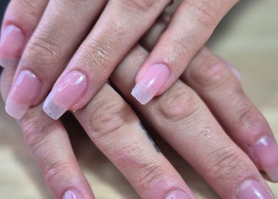 Beautifully manicured nails at Simply Nails and Wellbeing, Crawley, England, GB showcasing glossy pink finish.