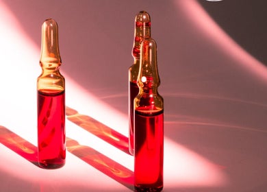 Vibrant red serum vials at Simply Nails and Wellbeing, Crawley, England, GB, showcasing rejuvenating treatments.
