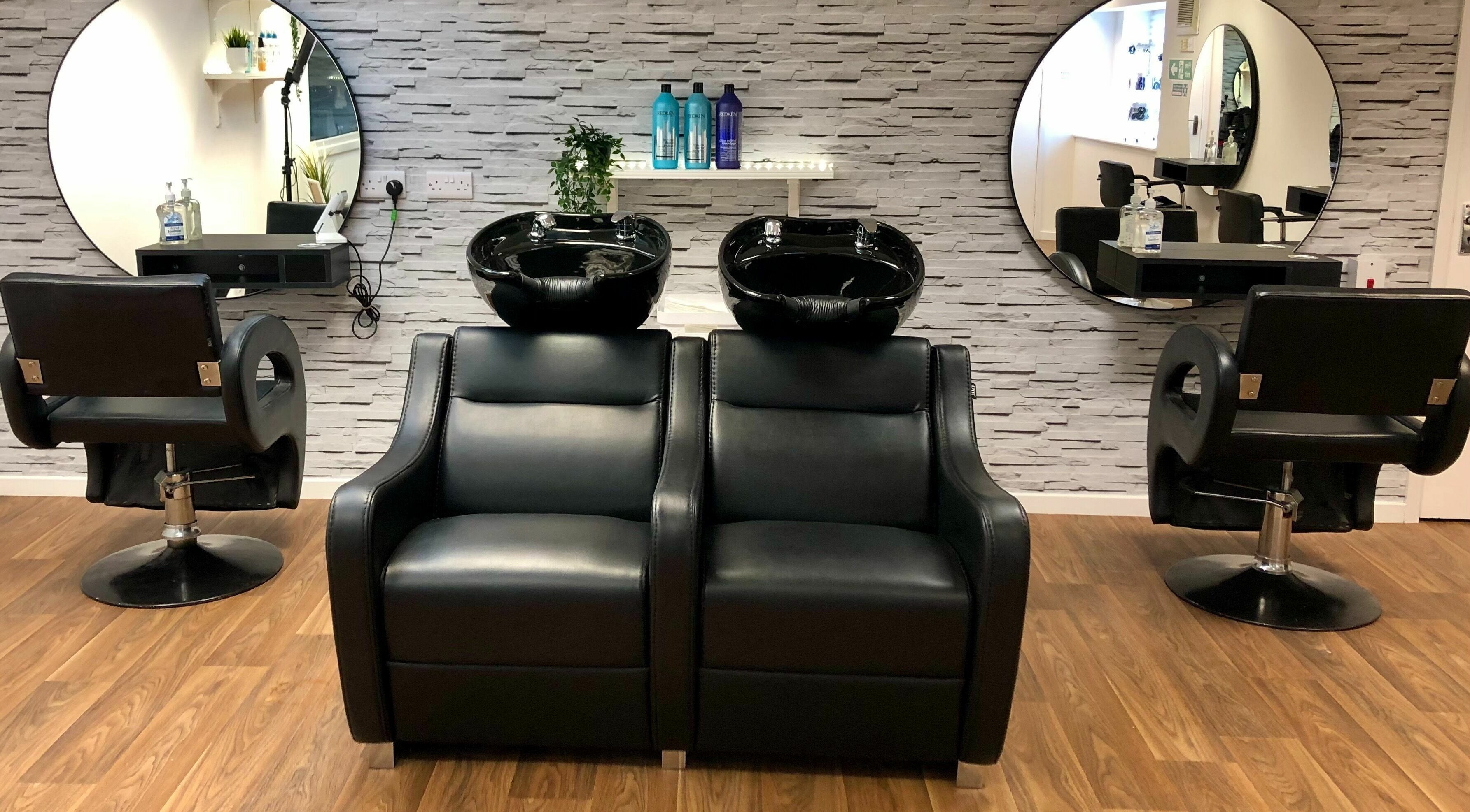 Modern wash stations at Choppers Family Hair Salon, Hedge End, England, GB with sleek mirrors and chairs.