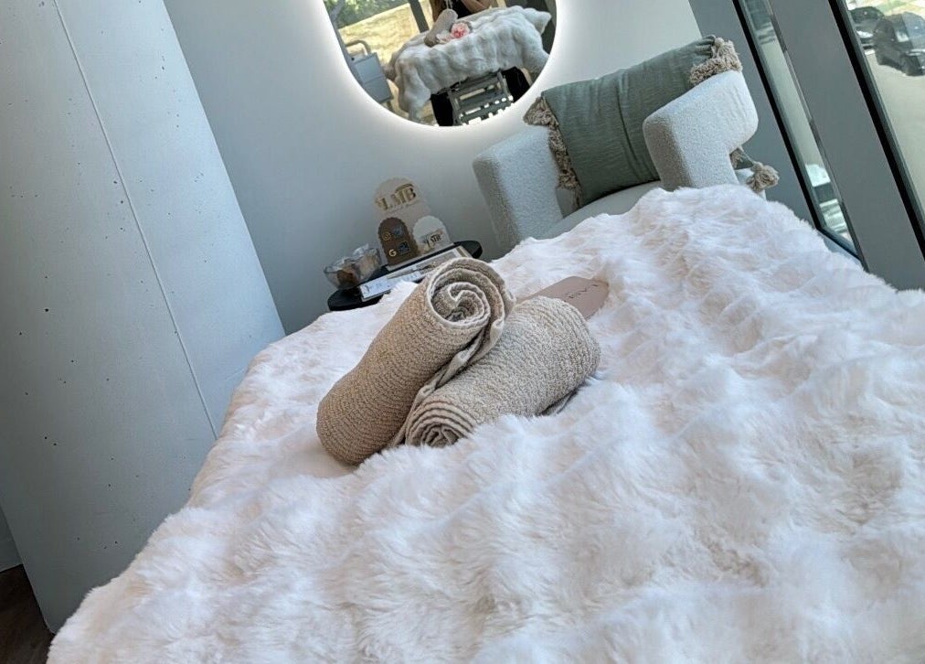 Plush spa bed at La Maison de Beauté - St Leonards, offering luxurious relaxation in St Leonards, NSW, AU.