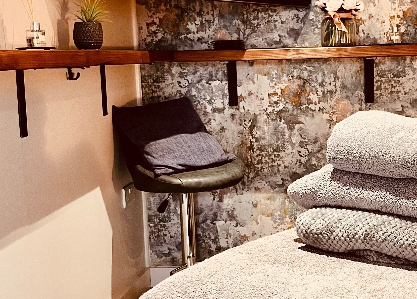 Relaxing massage room at Sports Massage with Paula in Llandudno Junction, Wales, GB with soft towels and plants.