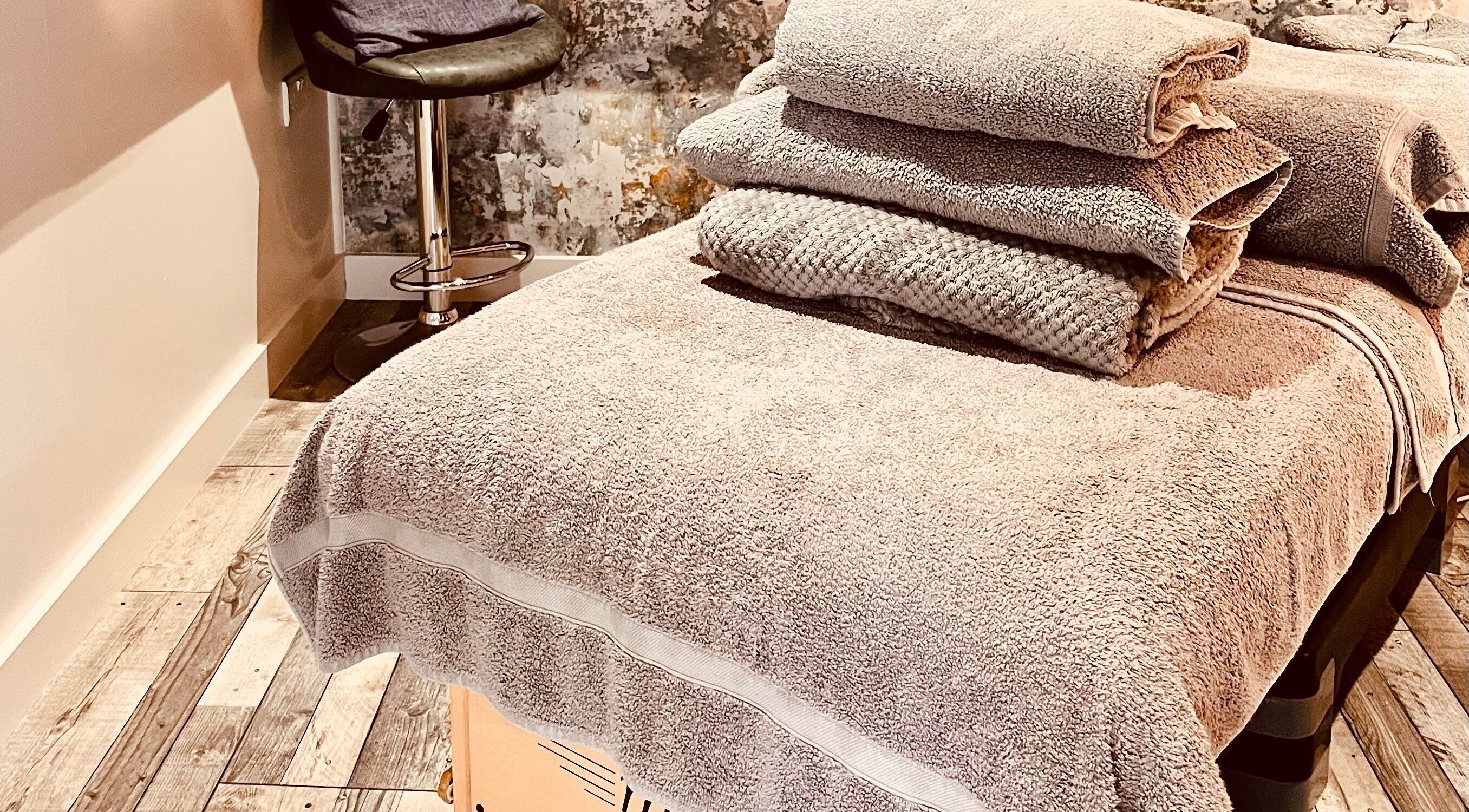 Relaxing massage room at Sports Massage with Paula, Llandudno Junction, Wales, GB with plush towels ready.