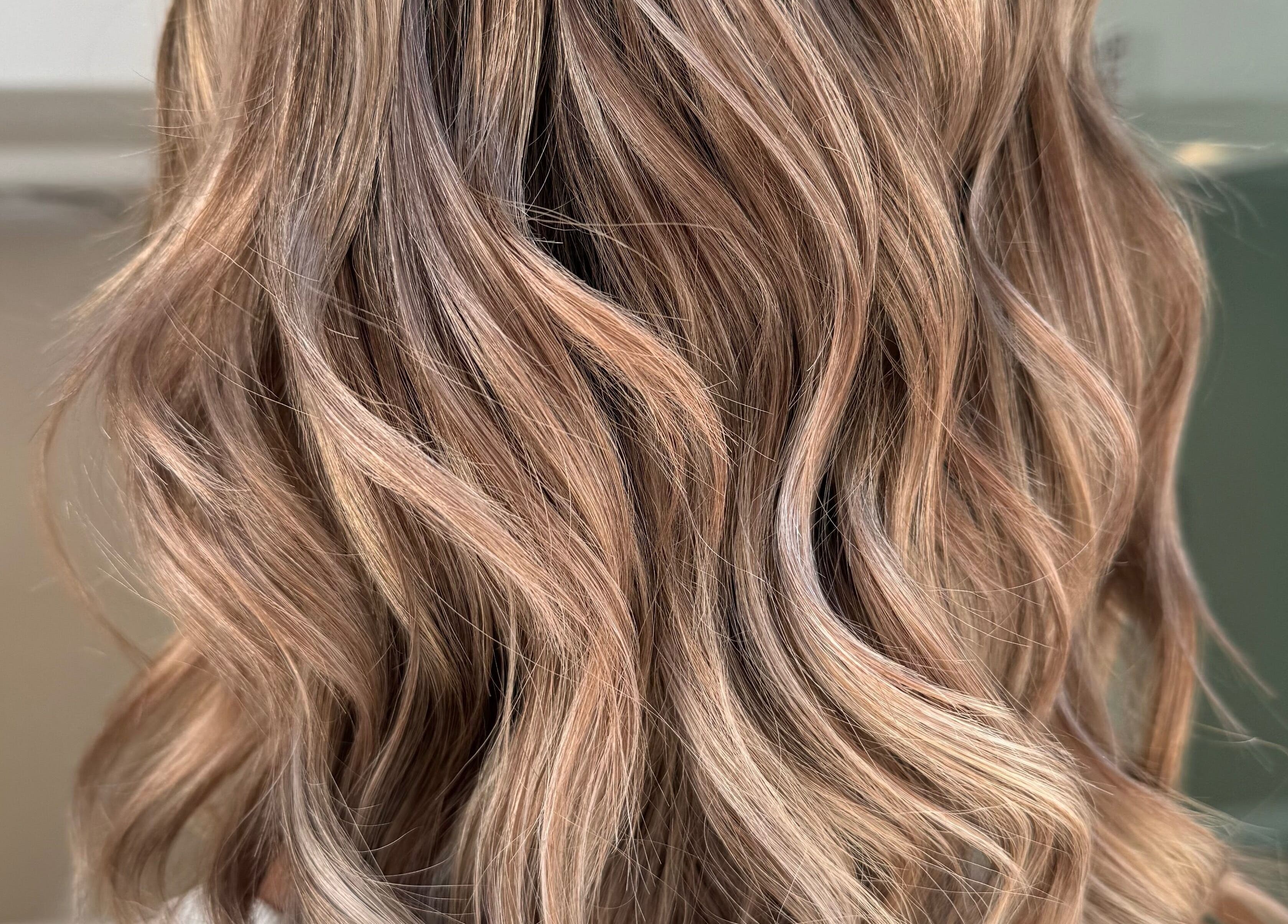 Styled wavy hair at Zoran Ducic salon, Tas-sliema, MT, showcasing elegant brown hues.