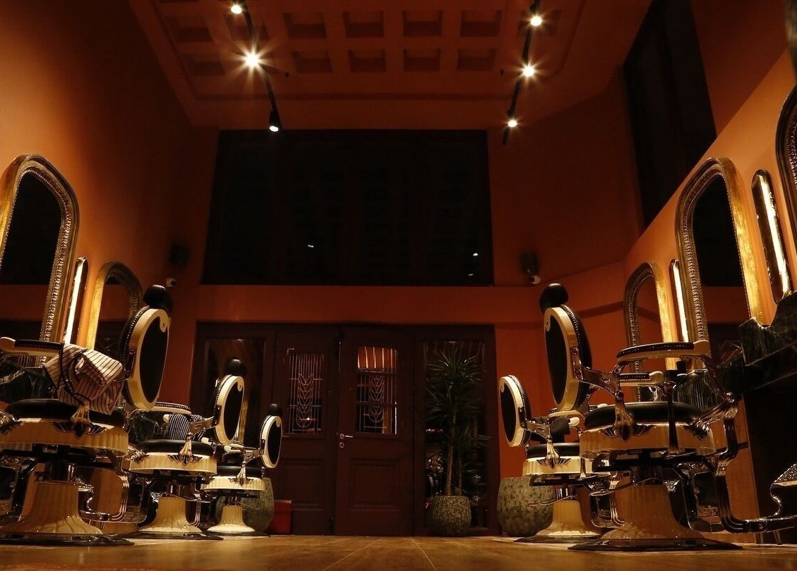 Luxurious interior of Hemingway Gentlemen’s Guild in Iraklio, Athens, GR featuring stylish barber chairs.