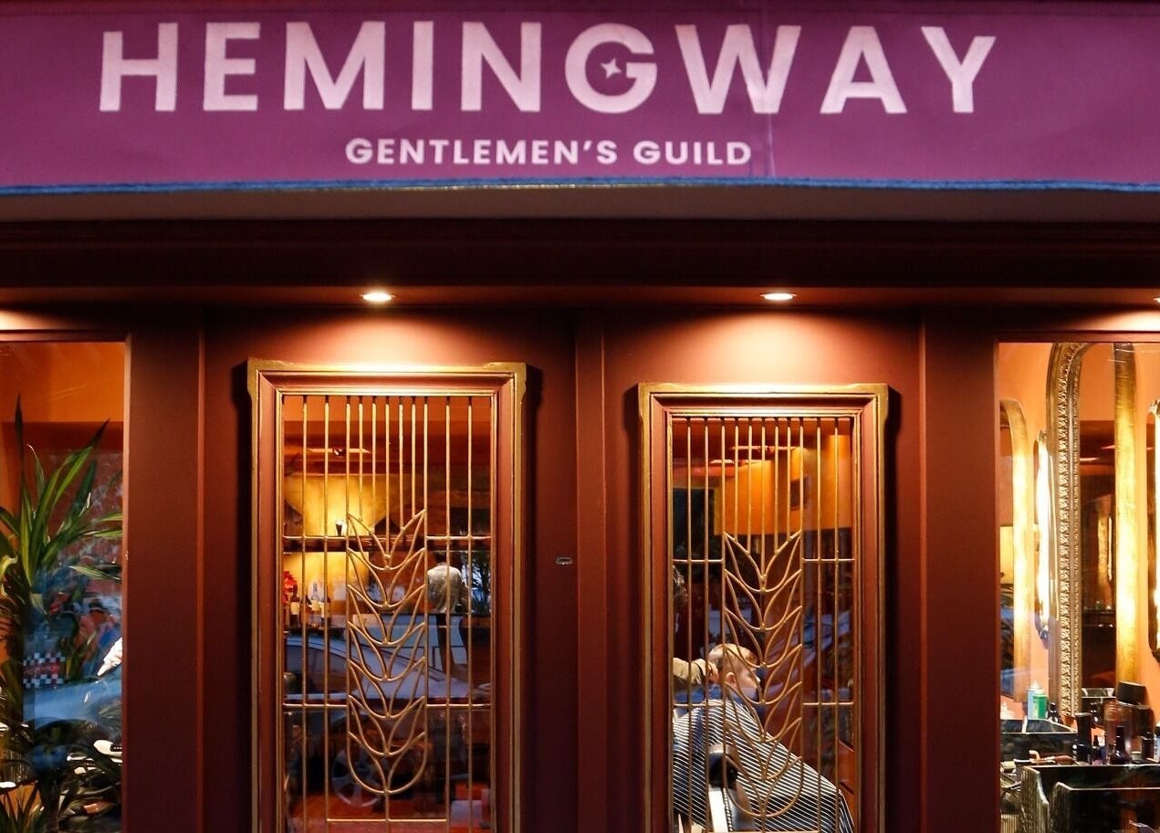 Entrance of Hemingway Gentlemen’s Guild in Iraklio, Athens, GR, showcasing elegant design and ambient lighting.