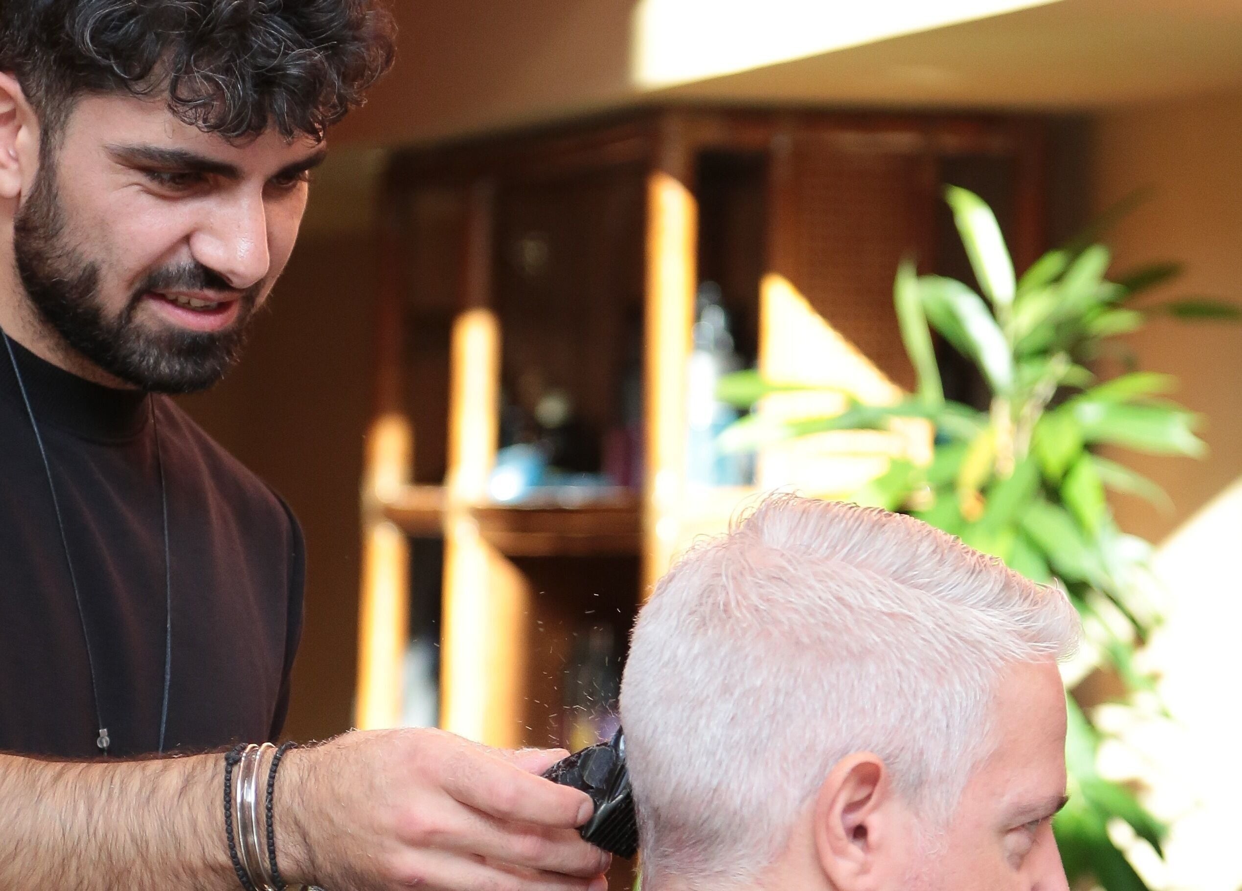 Hair stylist at Hemingway Gentlemen’s Guild, Iraklio, Athens, GR, perfects a gentleman's hairstyle.