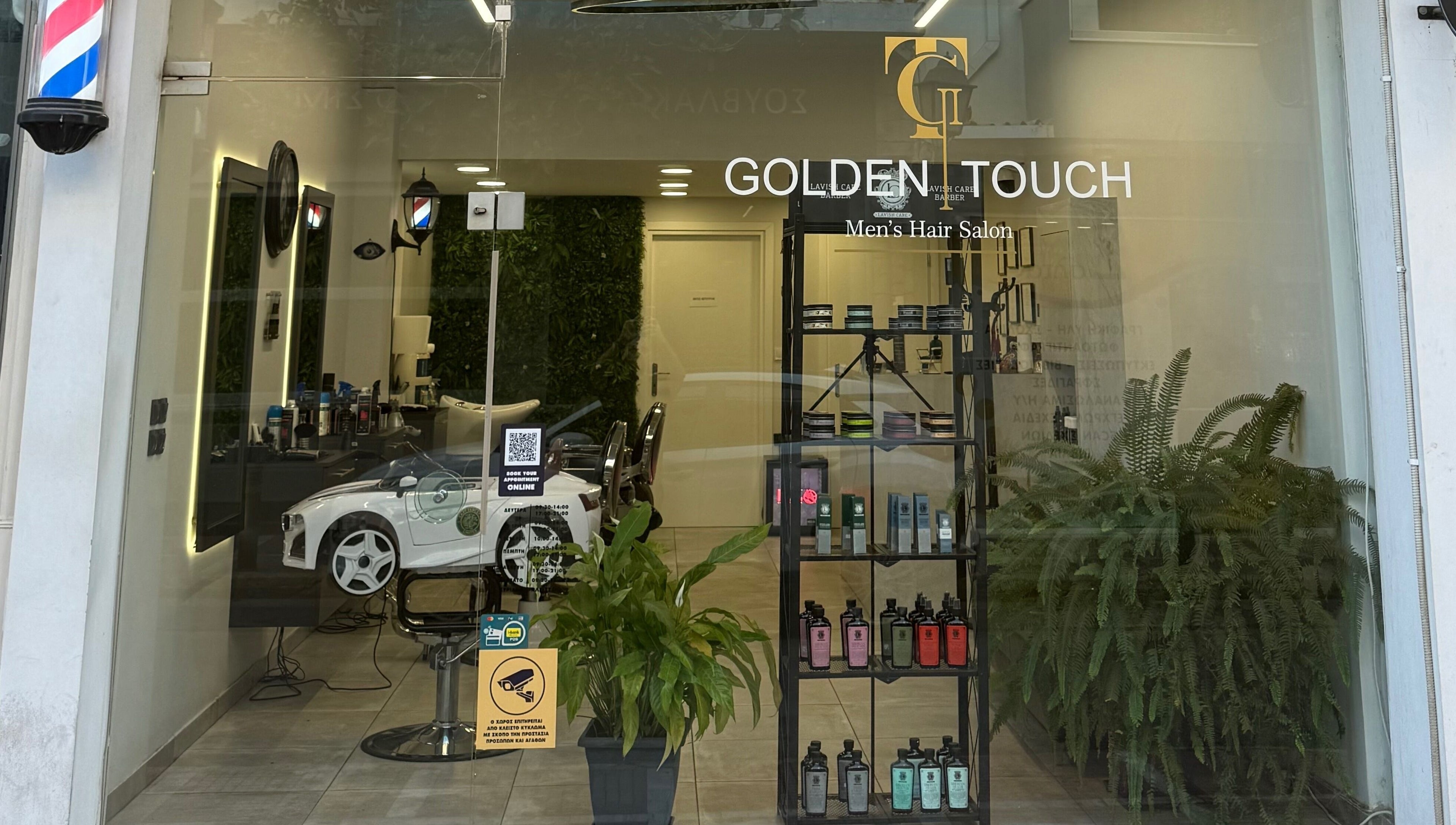 Κομψή πρόσοψη του Golden Touch MensHair στα Μέγαρα, GR με σύγχρονη διακόσμηση και φροντισμένα φυτά.