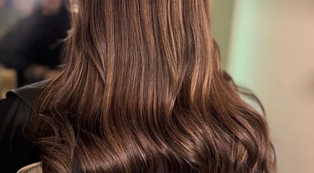 Shiny brown wavy hair styled at Hair Lounge With Ferne in Ash, England, GB.