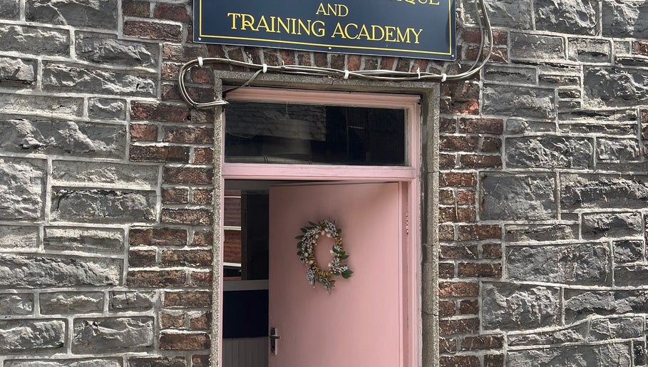 Charming entrance of Leigh B Makeup & Brows in Drogheda, County Louth, IE, featuring a pink door with a wreath.