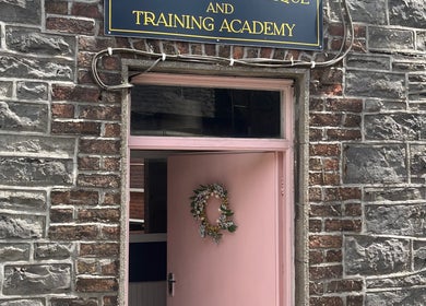 Charming entrance of Leigh B Makeup & Brows in Drogheda, County Louth, IE, featuring a pink door with a wreath.