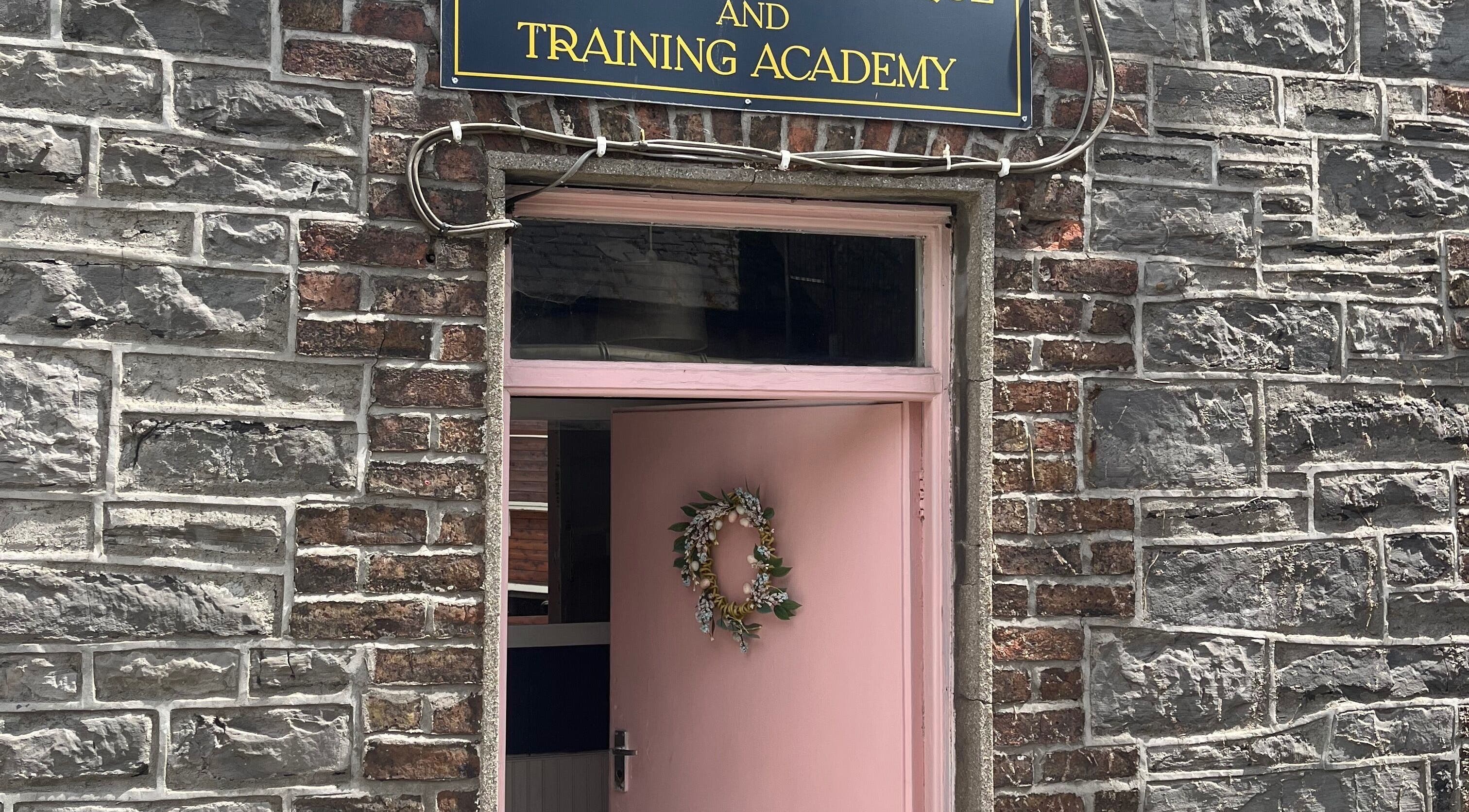 Entrance of Leigh B Makeup & Brows Artist in Drogheda, County Louth, IE, with a stylish pink door and wreath.