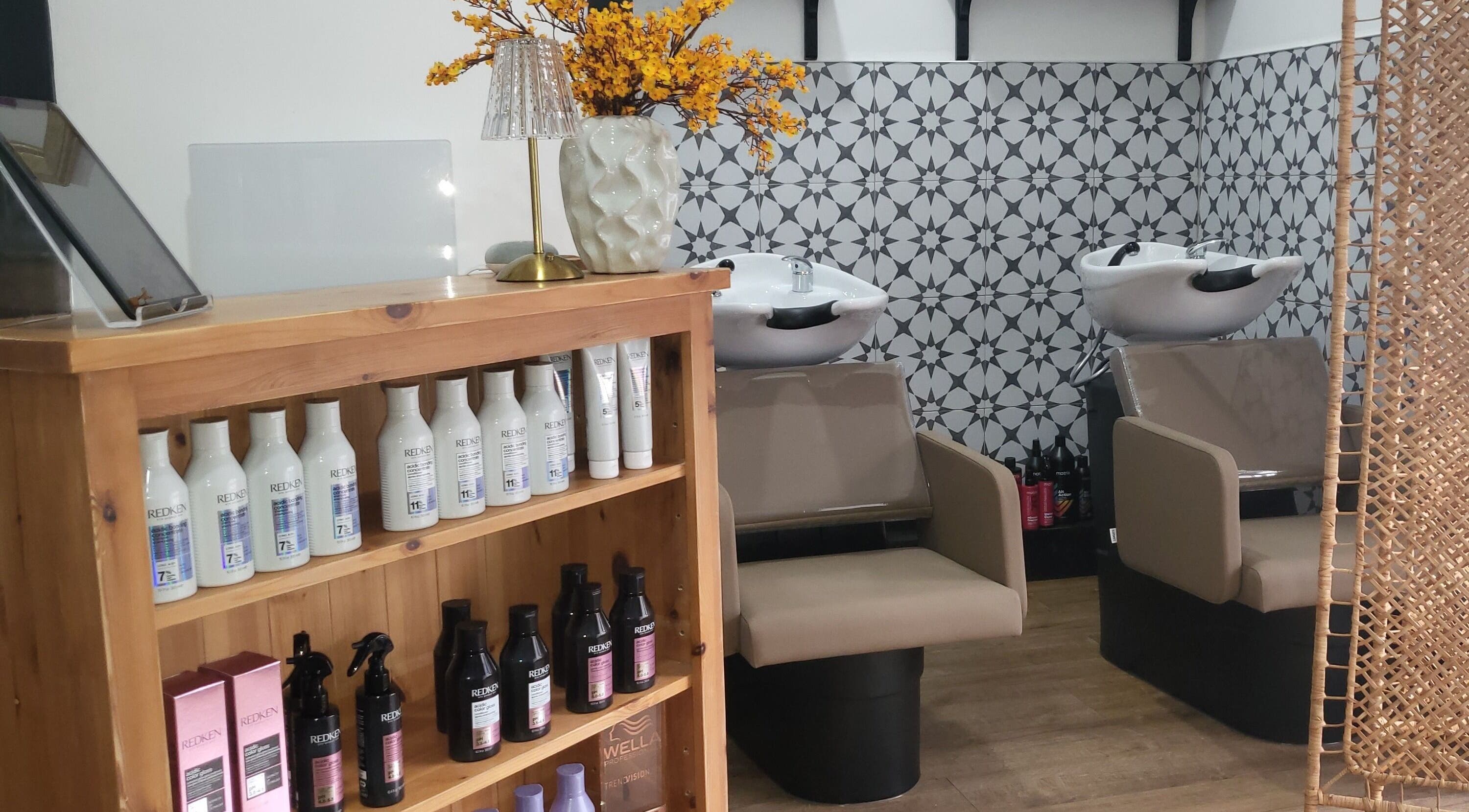 Stylish salon interior at Luna & Co. in Celbridge, County Kildare, IE, featuring wash stations and product shelves.