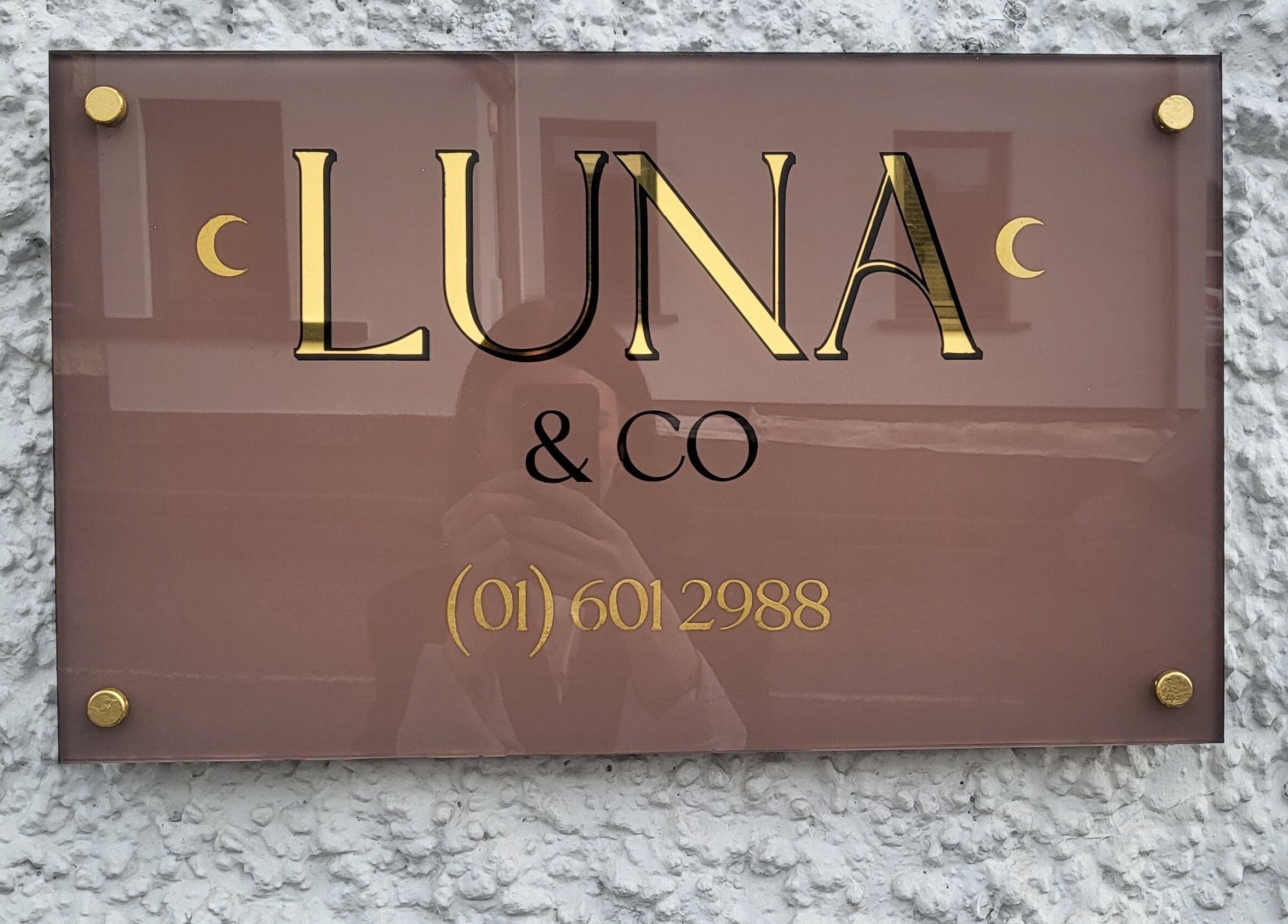 Elegant Luna & Co. sign in Celbridge, County Kildare, IE, against textured wall.