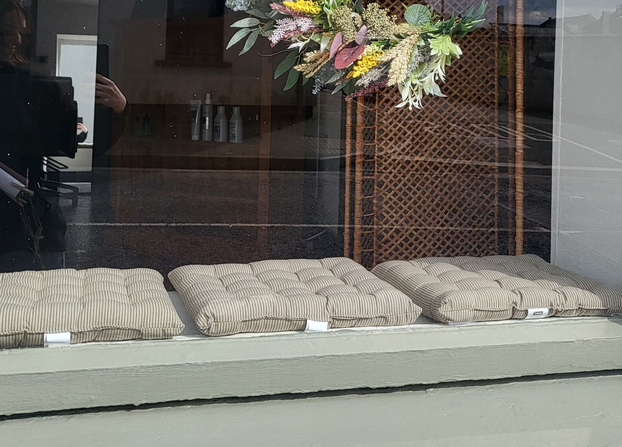 Cushioned seats and floral decor at Luna & Co., Celbridge, County Kildare, IE window display.
