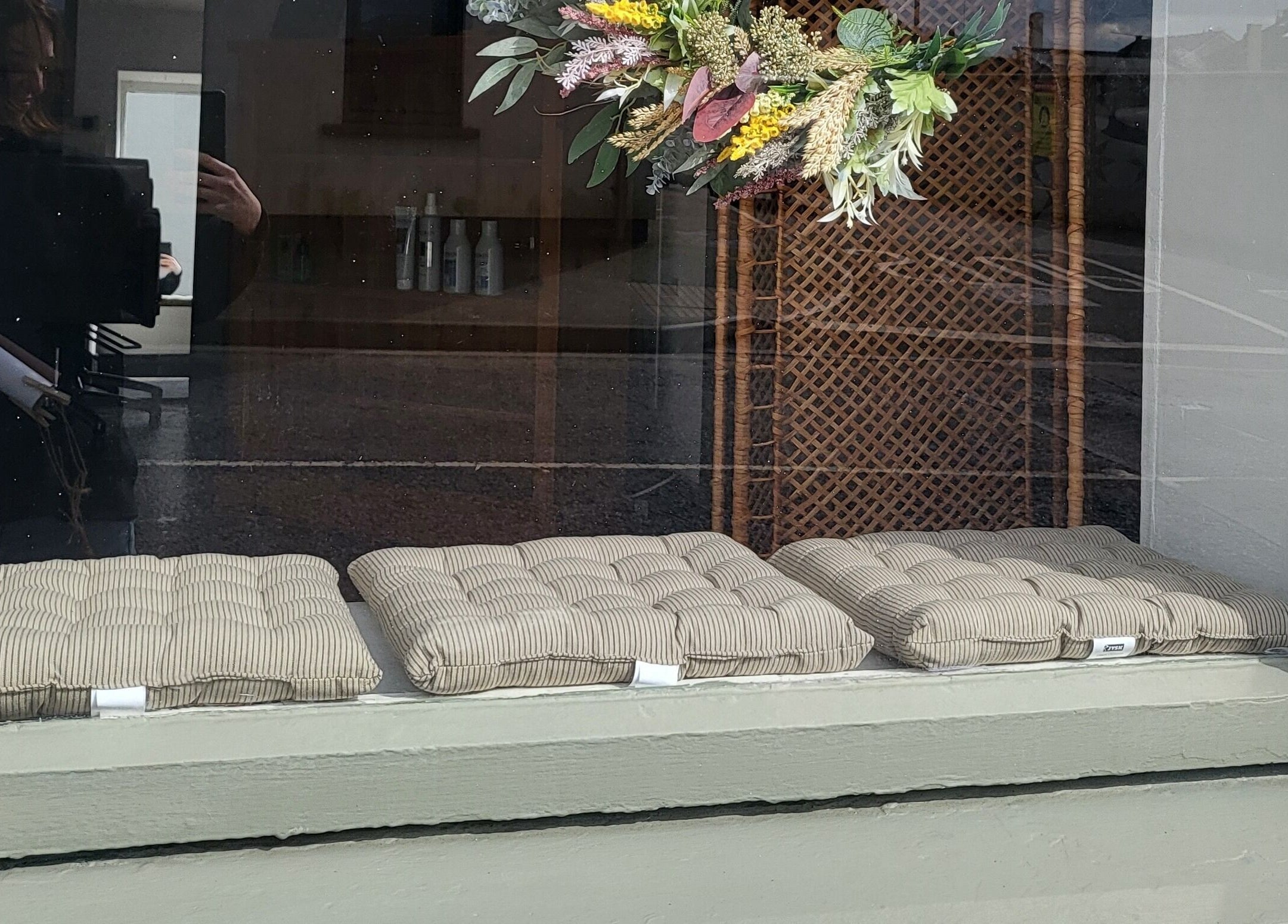 Cushioned seats and floral decor at Luna & Co., Celbridge, County Kildare, IE window display.