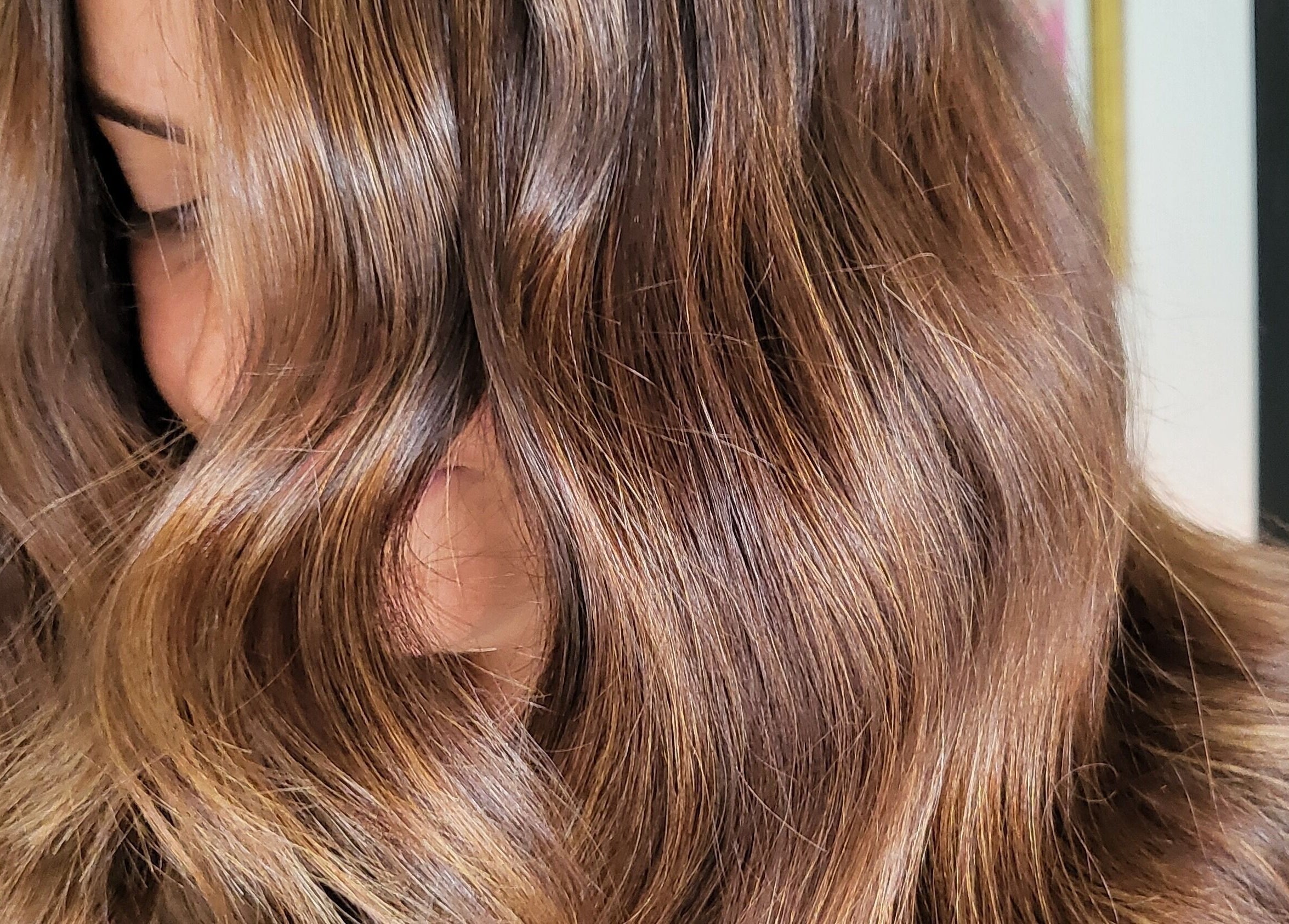 Close-up of shiny, wavy brown hair at Luna & Co., Celbridge, County Kildare, IE.